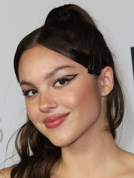 Olivia Rodrigo with high ponytail and black cut crease liner '70s makeup trend